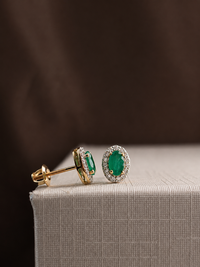 Arete oval de esmeralda con halo de diamantes en oro 14k